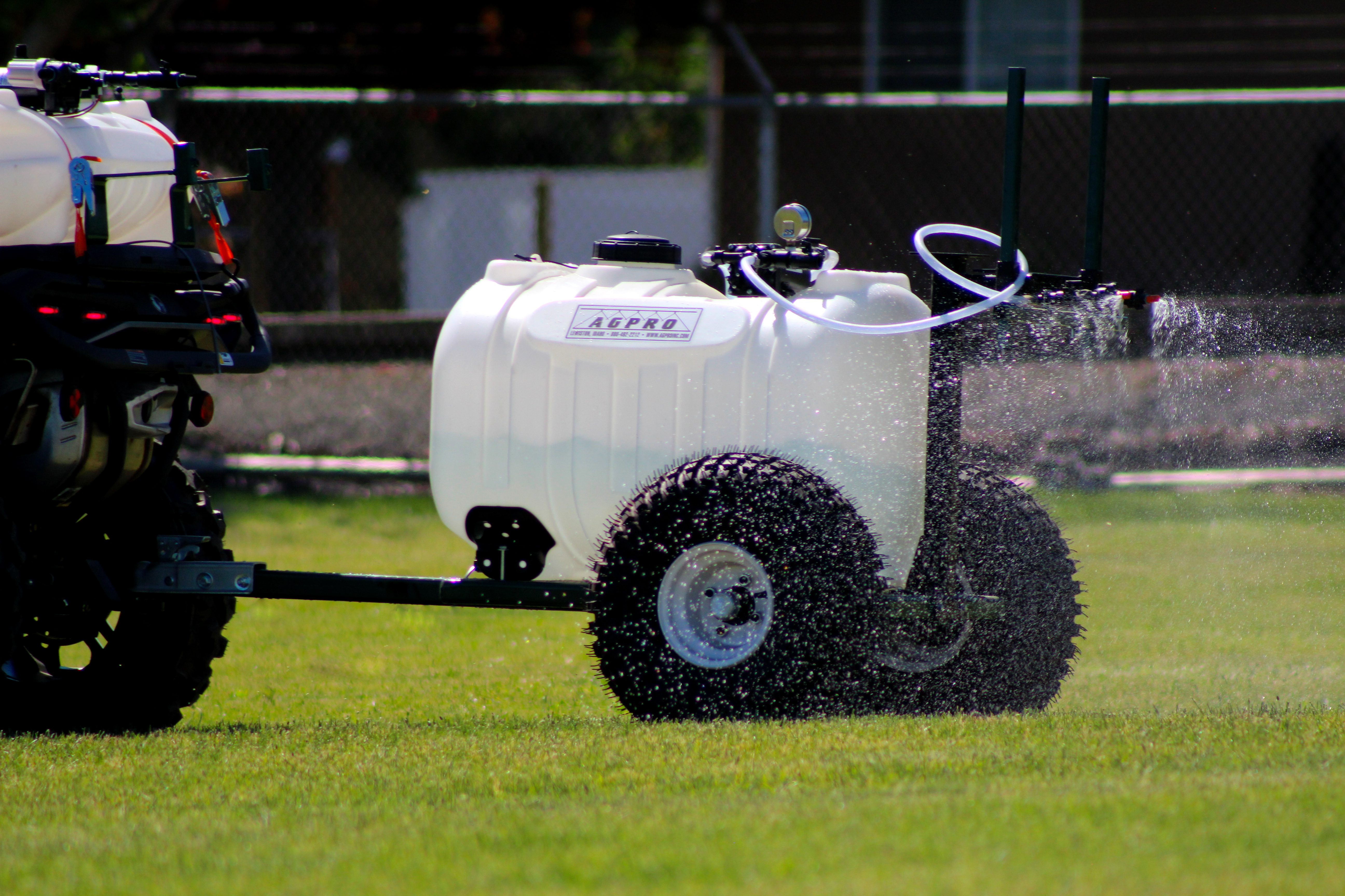 AGPRO tow-behind sprayer applying liquid in the field