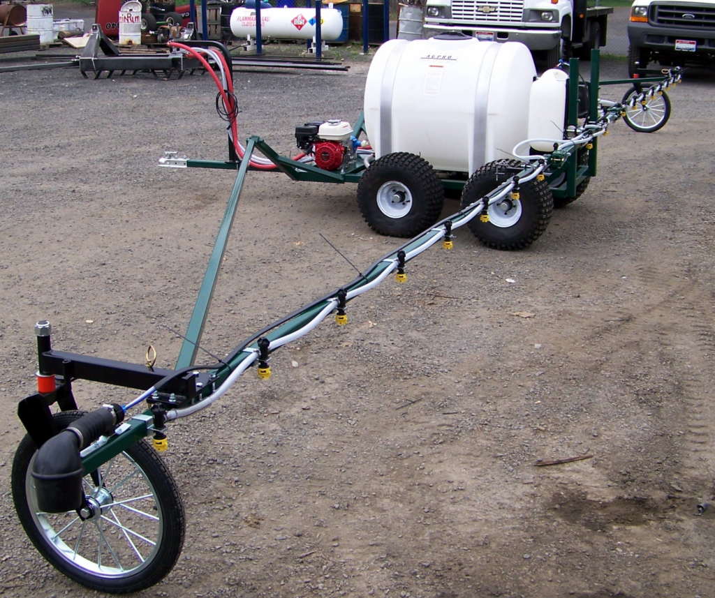 Model AT125-7560-40T 125 gallon tank, 7560C-R roller pump, 4hp Honda engine, tandem axles, and 40ft trailing boom - winged out for spraying operation. Shown with optional foam marker system.